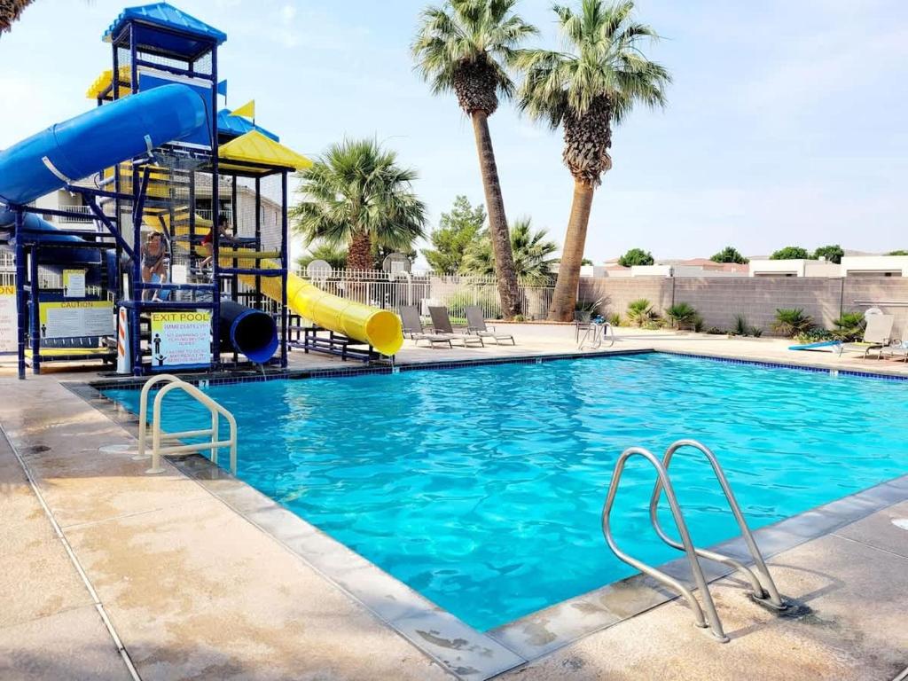 a swimming pool with a slide and a playground at 20| Vue at Green Valley with Community Pool in St. George