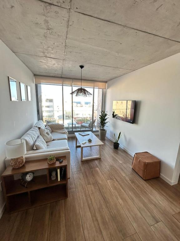 a living room with a couch and a table at An oasis in the middle of the noise in Punta del Este