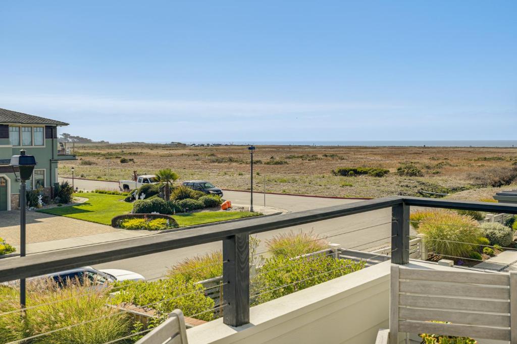 a view of the beach from the balcony of a house at Walk to Ocean Luxe Family Home in Half Moon Bay! in Half Moon Bay