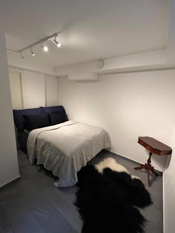 a bedroom with a bed and a table at Apartment for rent in Oslo