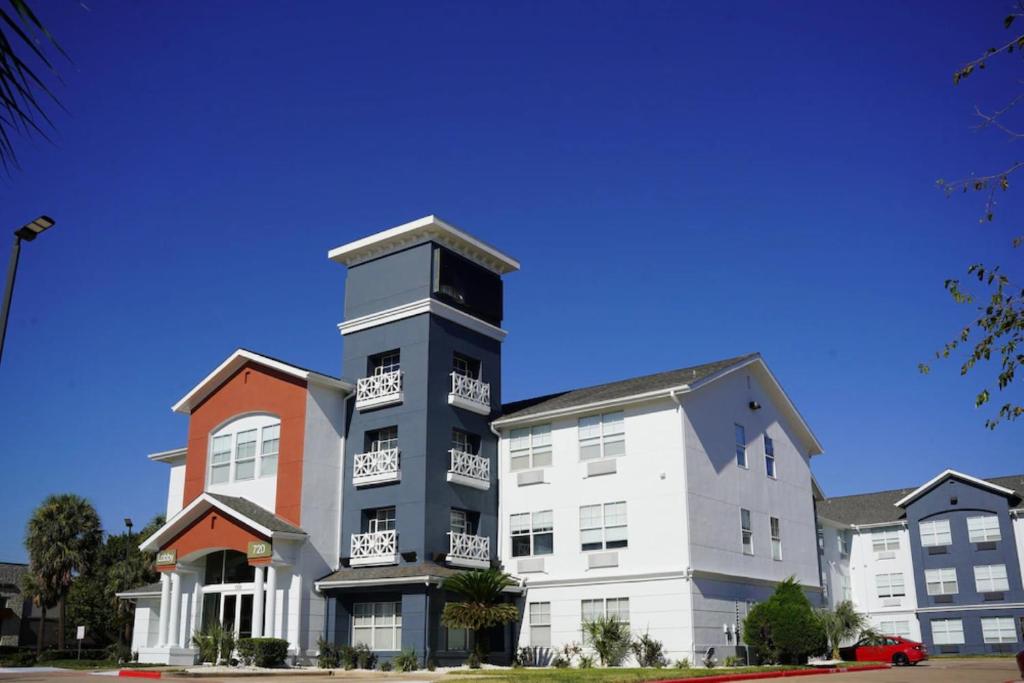 a building with a clock tower on top of it at Candlewood Suites Houston Space Center - Webster in Webster