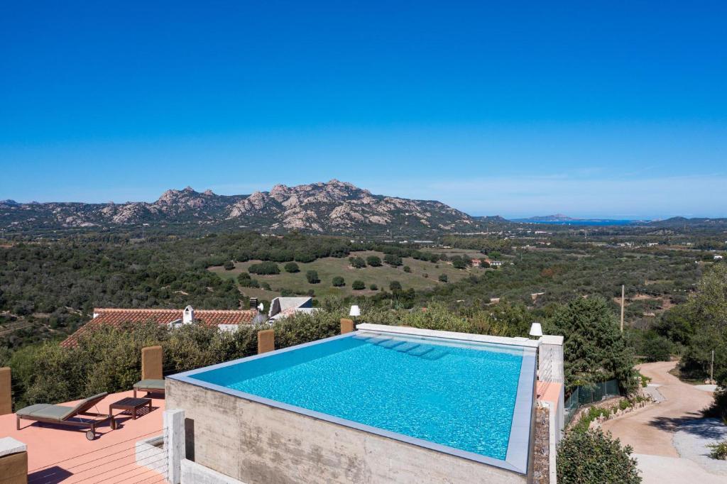 a villa with a swimming pool with a view at Villa Sole Tra i Ginepri in Olbia