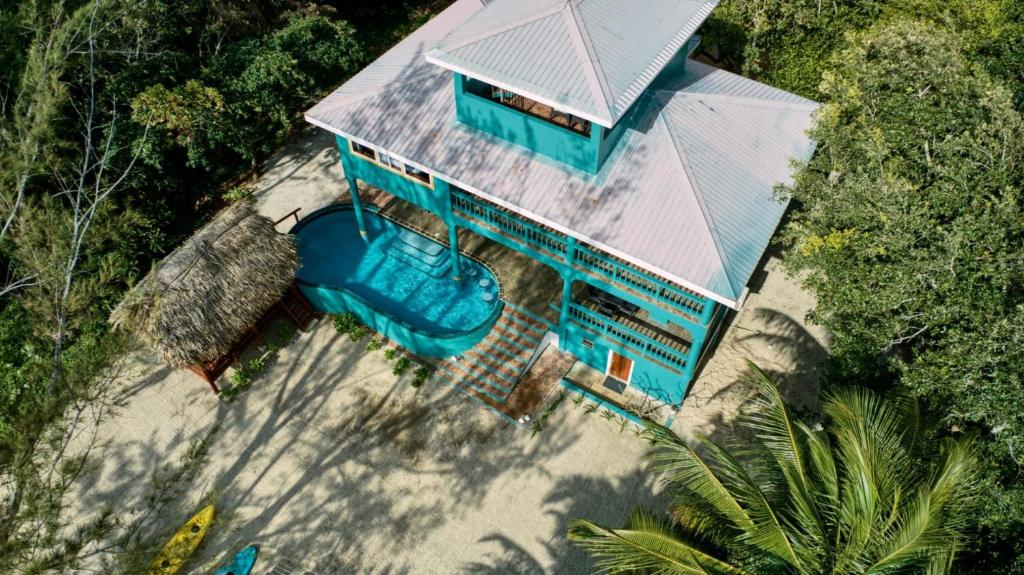 an overhead view of a house with a swimming pool at Toucan Dance Villa - 3BR Beachfront wPool Ocean Views in Maya Beach