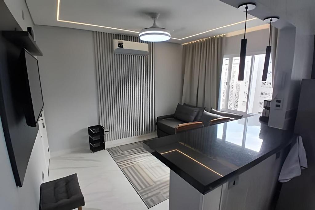 a living room with a couch and a table at SHB - Apto Aconchegante Família Moderno in Santos