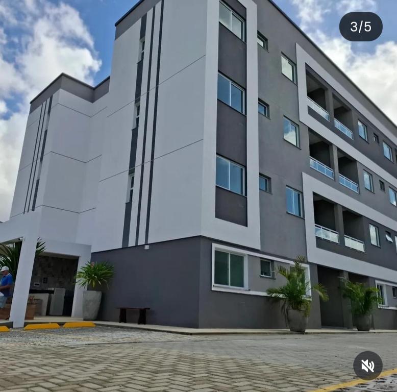 a large white building with plants in front of it at Cantinho da paz in Fortaleza