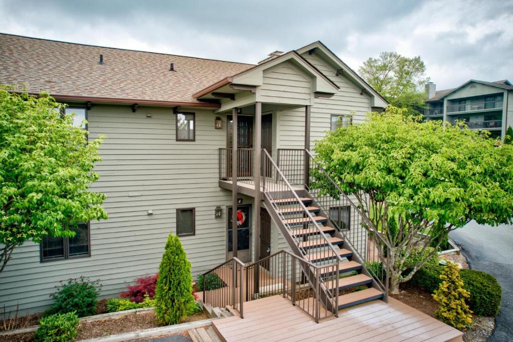 a house with a wooden staircase in front of it at Chetola: Holly 4 in Blowing Rock