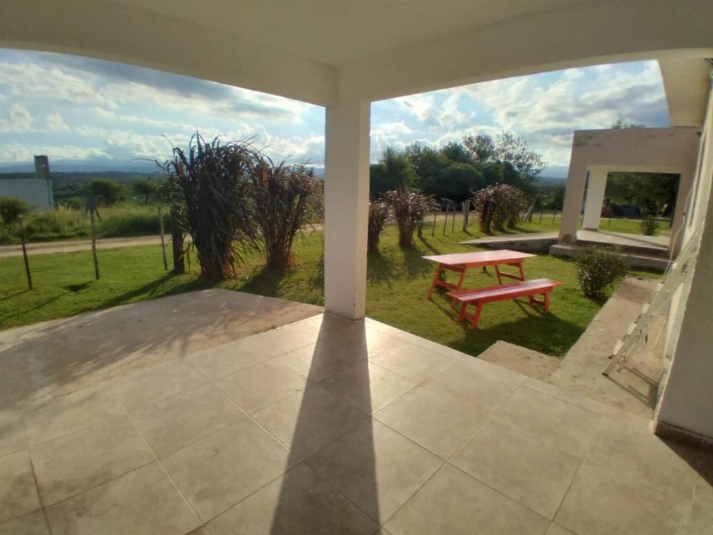 a view of a patio with a red bench and a window at Cabañas Hawaii in Bialet Massé