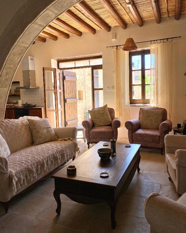 a living room with couches and a coffee table at Levanda House - Traditional House Vasa Koilaniou in Vasa Kilaniou