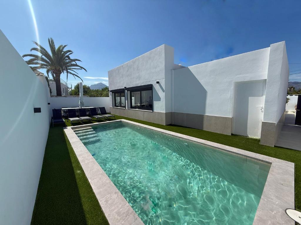 a swimming pool in front of a house at Villa Jupiter by Albir Proper Properties in Albir
