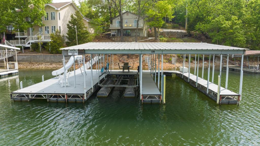 a dock with a ramp in the water at Amazing Lakefront Paradise with Perfect Location in Osage Beach