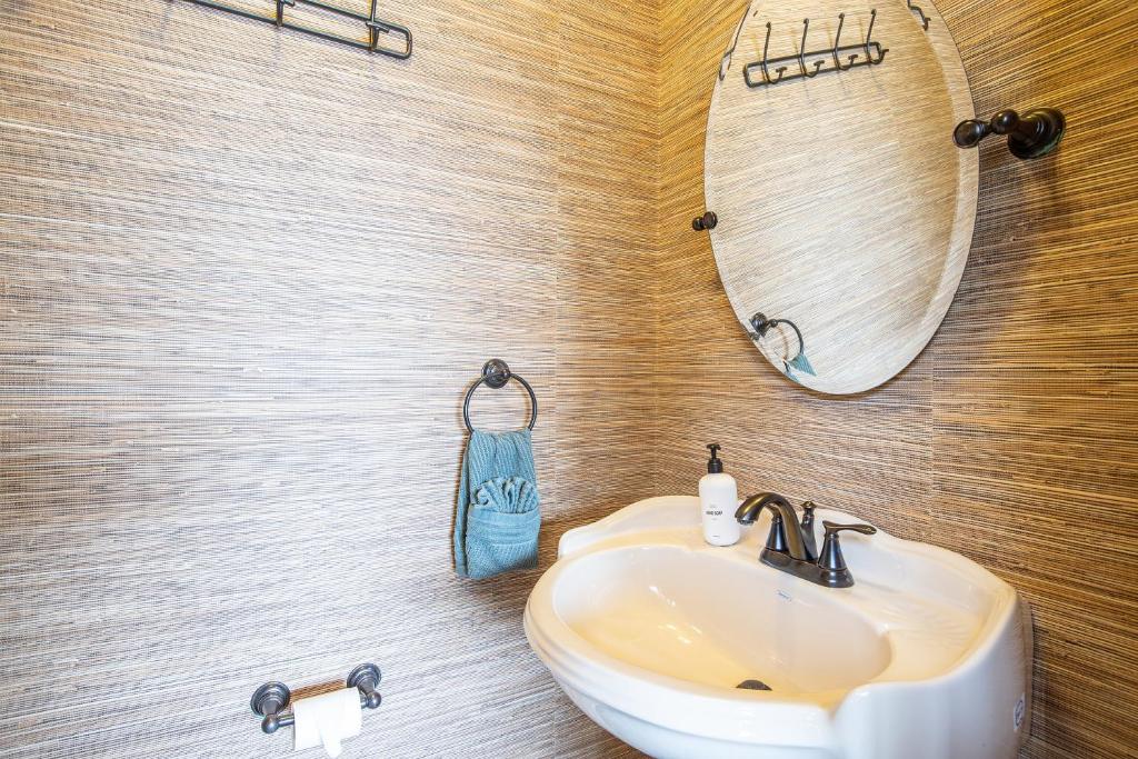 a bathroom with a sink and a mirror at Amazing Cove, Fenced Yard, & Game Room! in Damsel