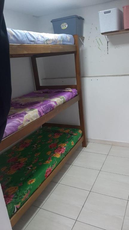 two bunk beds in a room with a floor at Pousada El Shaday compartilhada in Barueri