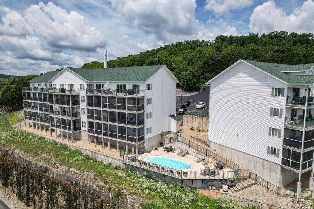 an aerial view of a hotel with a swimming pool at Boat Slip, 3 Pools, Golf, Ozarks Ampitheater, & Amazing Lake Views at the 13mm Big Niangua in Roach