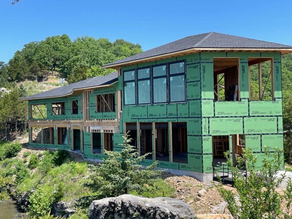 a house being built on top of a hill at Expansive Lakefront Estate with Private Pool & Movie Theater at 43mm in Purvis