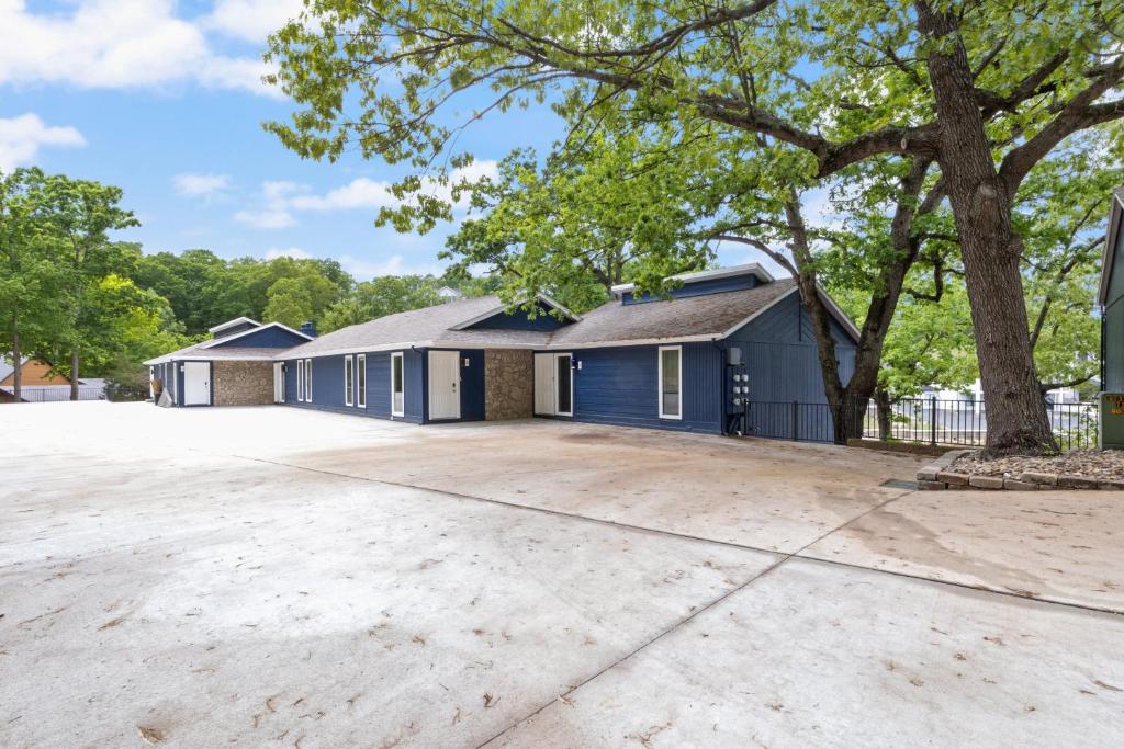 a house with a driveway in front of it at Our Cove Retreat - Perfect for Wave-Free Swimming, Tanning & Prime Location Fun! in Lake Ozark