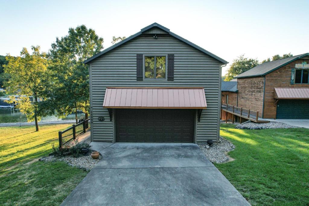 a garage with a window on the side of a house at Hot Tub, Fire Pit, Awesome Loft & Amazing Views! in Buck Creek