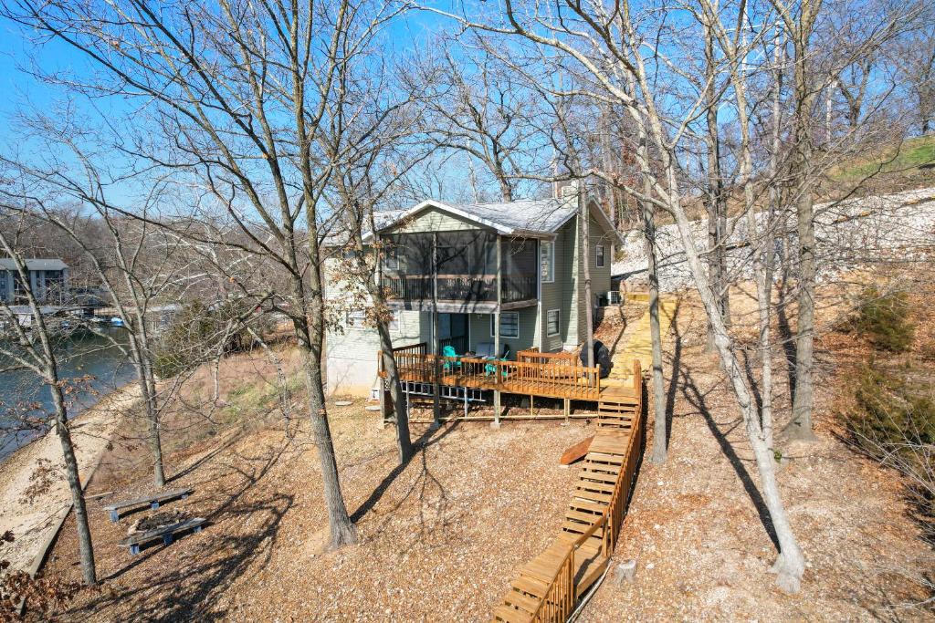 a house on the side of a hill with a deck at Spacious, Central Location, Fire Pit, Boat Slip in Lake Ozark