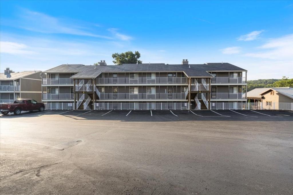 a large apartment building with a parking lot at LazyDays Pet-Friendly Condo w/ Pool & Slip at 3M in Damsel