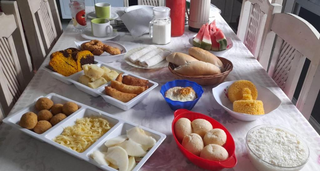 a table with many different types of food on it at Pousada Recanto da Vila in Mucugê