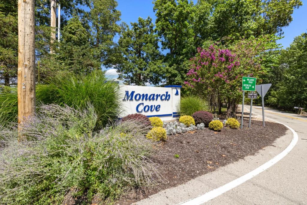 a sign for a momedomed cave in a garden at Main Channel Views, Screened Porch, Pool & Boat Slip in Lake Ozark