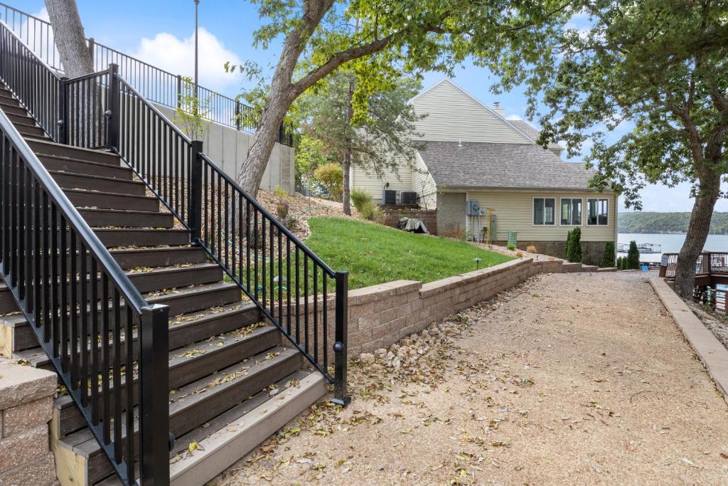 a set of stairs leading to a house at Poolside Condo with Amazing Lake Views & Design in Damsel