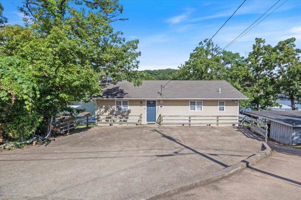 a house with a driveway in front of it at Perfect Family House in Osage Beach with Expansive Deck, Private Dock, & Boat Slip in Damsel