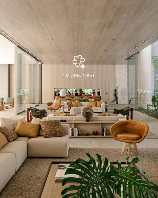 a living room with couches and tables in a building at Pulso Hotel Faria Lima in São Paulo