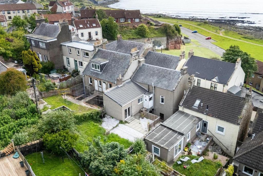 an aerial view of a house with the ocean at Fife coastal corner in Buckhaven