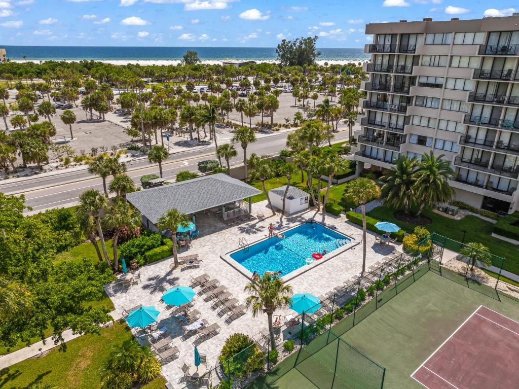 an aerial view of a pool with palm trees and a building at Our House at the Beach W-704 in Siesta Key