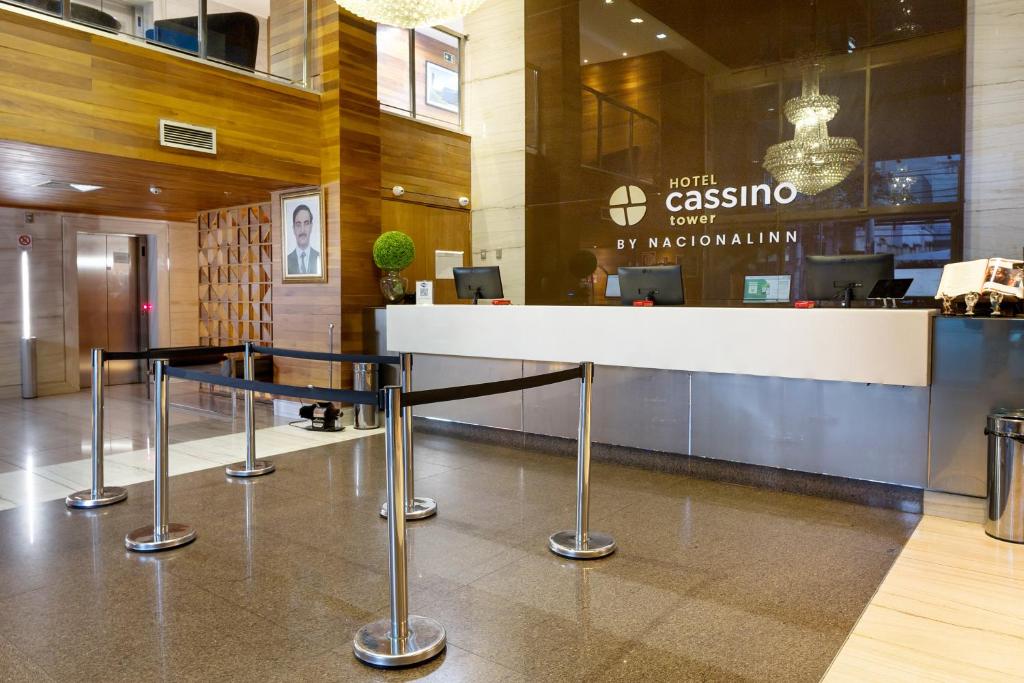 a lobby with a reception desk in a building at Cassino Tower Savassi -Antigo Tryp by Wyndham in Belo Horizonte