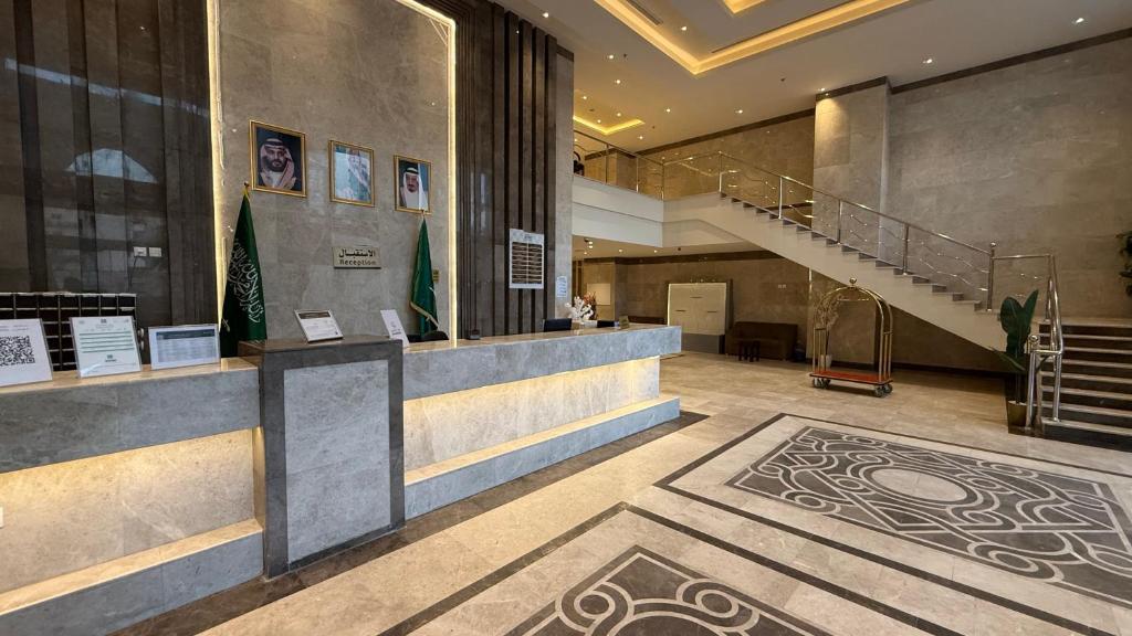 a lobby of a building with a staircase and a museum at اصول الجوهرة العزيزية Asoul Al Jawhara Al Azizia in Al ‘Azīzīyah