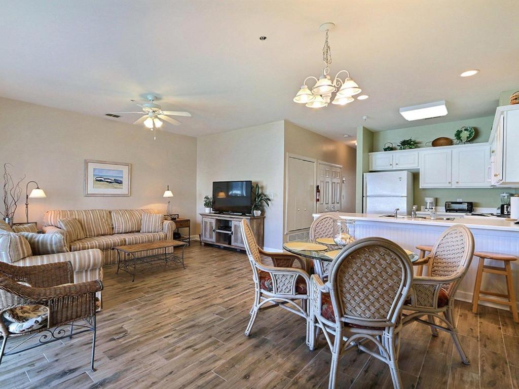 a kitchen and living room with a table and chairs at South Beach Retreat in Tybee Island