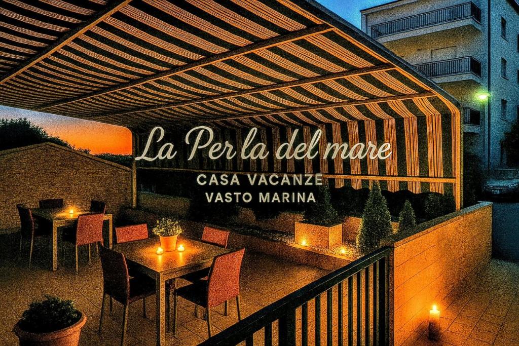 a restaurant with tables and chairs on a balcony at "La perla del mare" Vasto Marina in Vasto