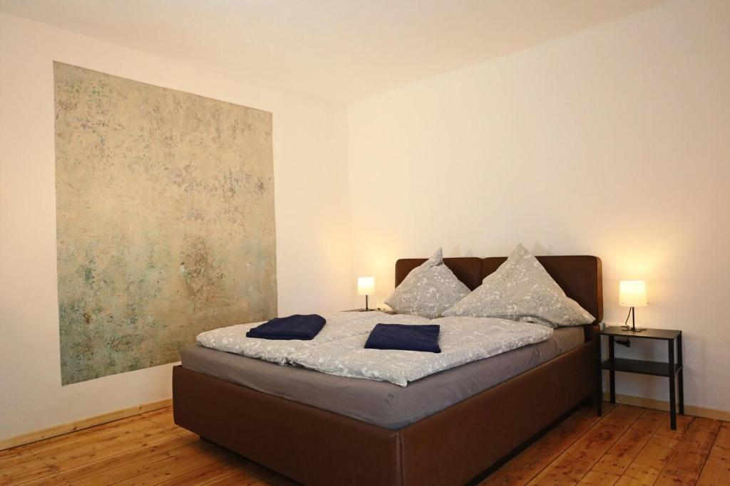 a bedroom with a bed with two lamps on it at Gemütliches Schmuckstück mit zwei Schlafzimmern in Mügeln