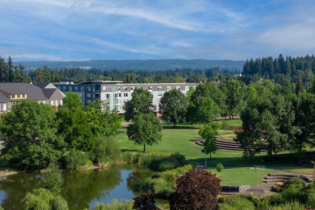 an aerial view of a campus with a pond at Aloft Hillsboro-Beaverton in Hillsboro