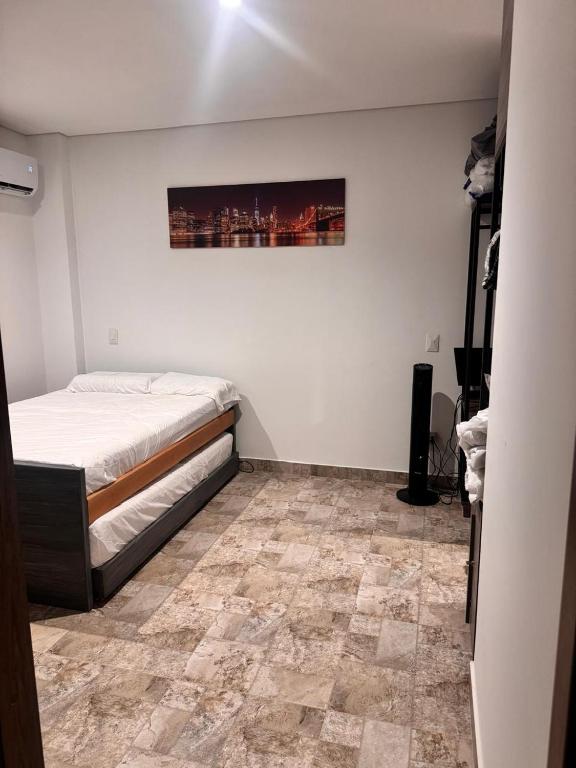 a bedroom with a bed and a tile floor at Rodadero Extasis in Puerto de Gaira