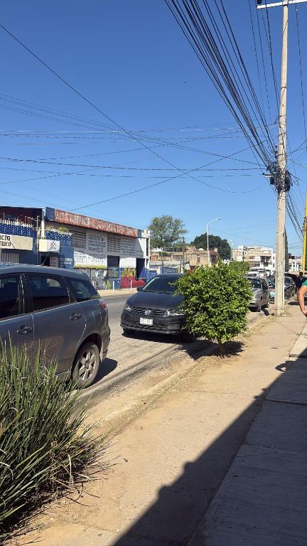 two cars parked on the side of a street at Casa Oaxaca in Oaxaca City