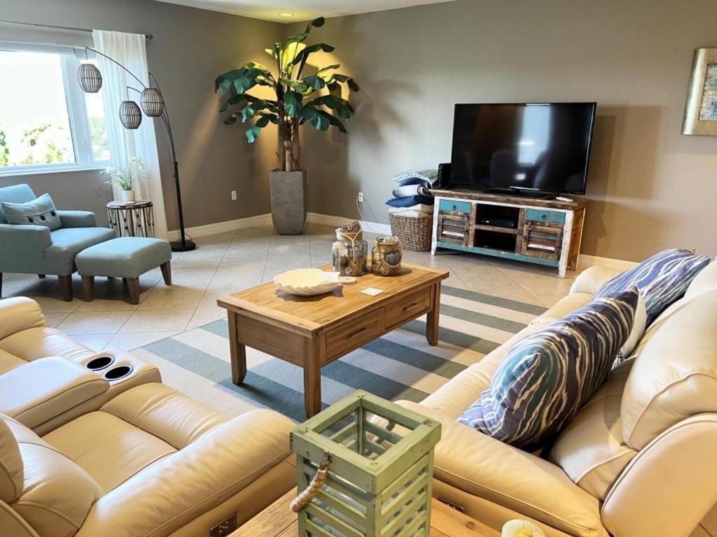 a living room with a couch and a coffee table at Manasota Key Gem - Pool and Hot Tub - Beach Views in Punta Gorda Beach