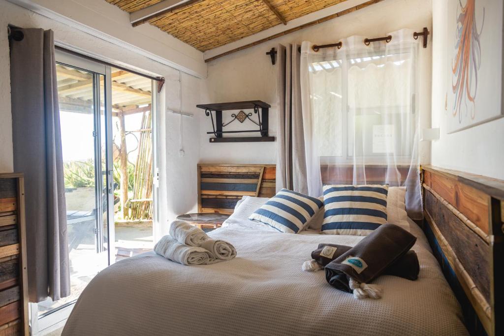 a bedroom with a bed with towels on it at Carmela Suites Cabo Polonio in Cabo Polonio