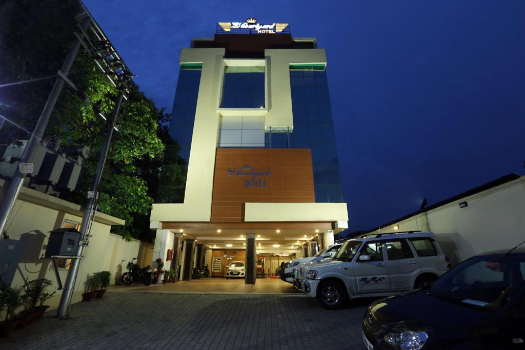 einem weißen SUV vor einem Gebäude in der Unterkunft Hotel D Courtyard in Guwahati