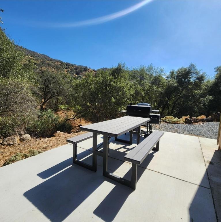 a picnic table with a grill sitting on a sidewalk at The Getaway -6 miles from SNP in Three Rivers