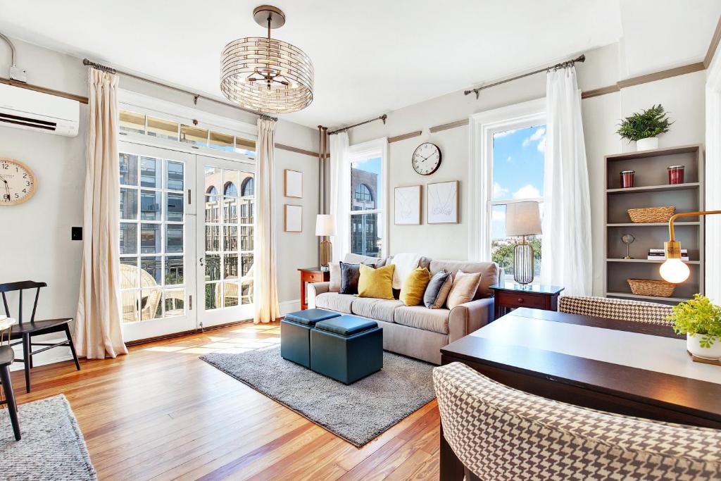 a living room with a couch and a table at Downtown at the Derenne in Savannah