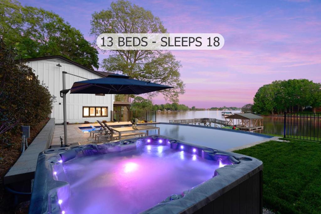 a swimming pool with purple lights in a backyard at Fox Run w/Heated Pool & Optional Boat Rental in Westport