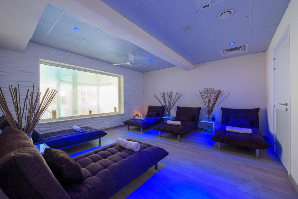 a living room with couches and blue lighting at Golden Bay Beach Hotel in Larnaca