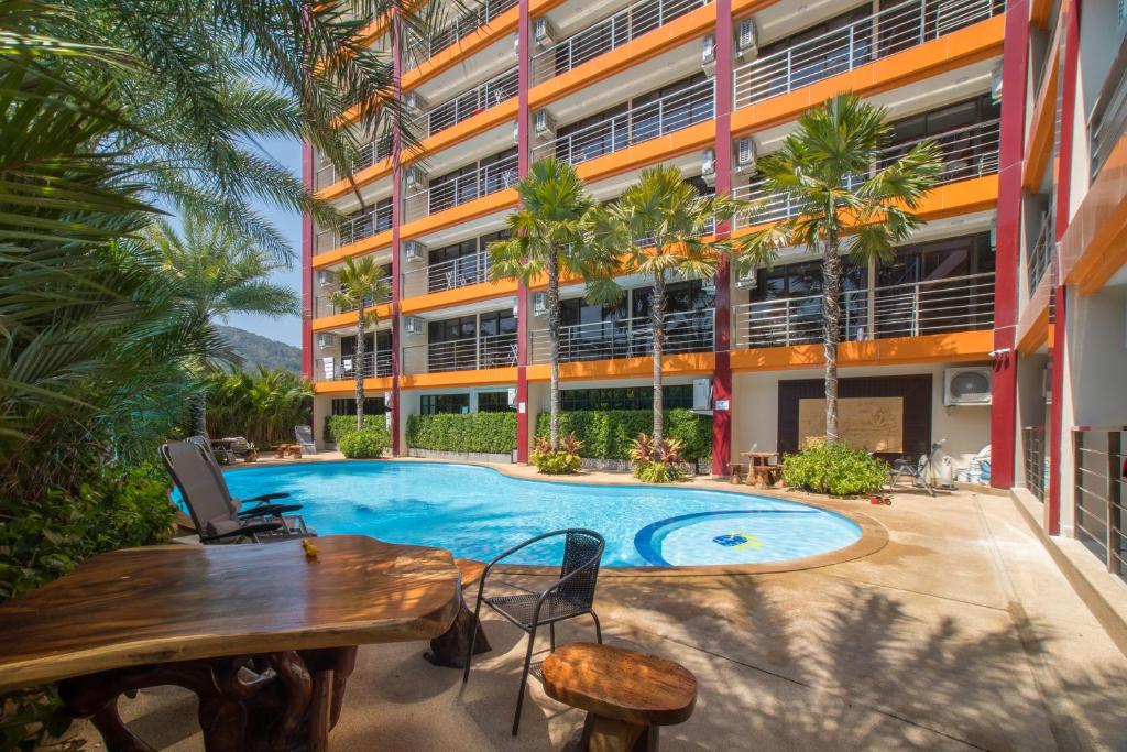 an apartment patio with a swimming pool and a building at NARA Condo 1BR Pool View NBC Nai Harn in Nai Harn Beach