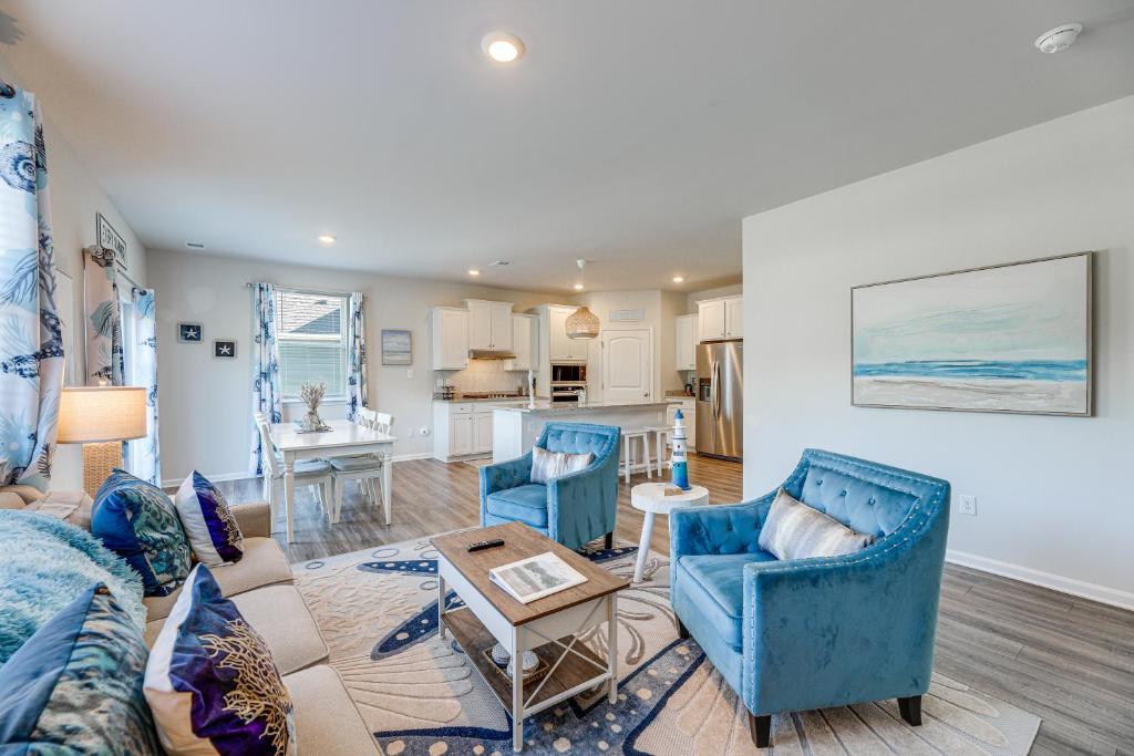 een woonkamer met blauwe meubels en een keuken bij Game Room and Patio Spacious Ocean View Home in Wilgus Subdivision