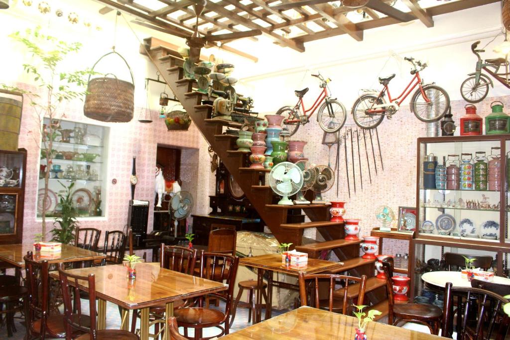 een restaurant met tafels en fietsen aan de muur bij Campbell Antique Hotel & Cafe in George Town