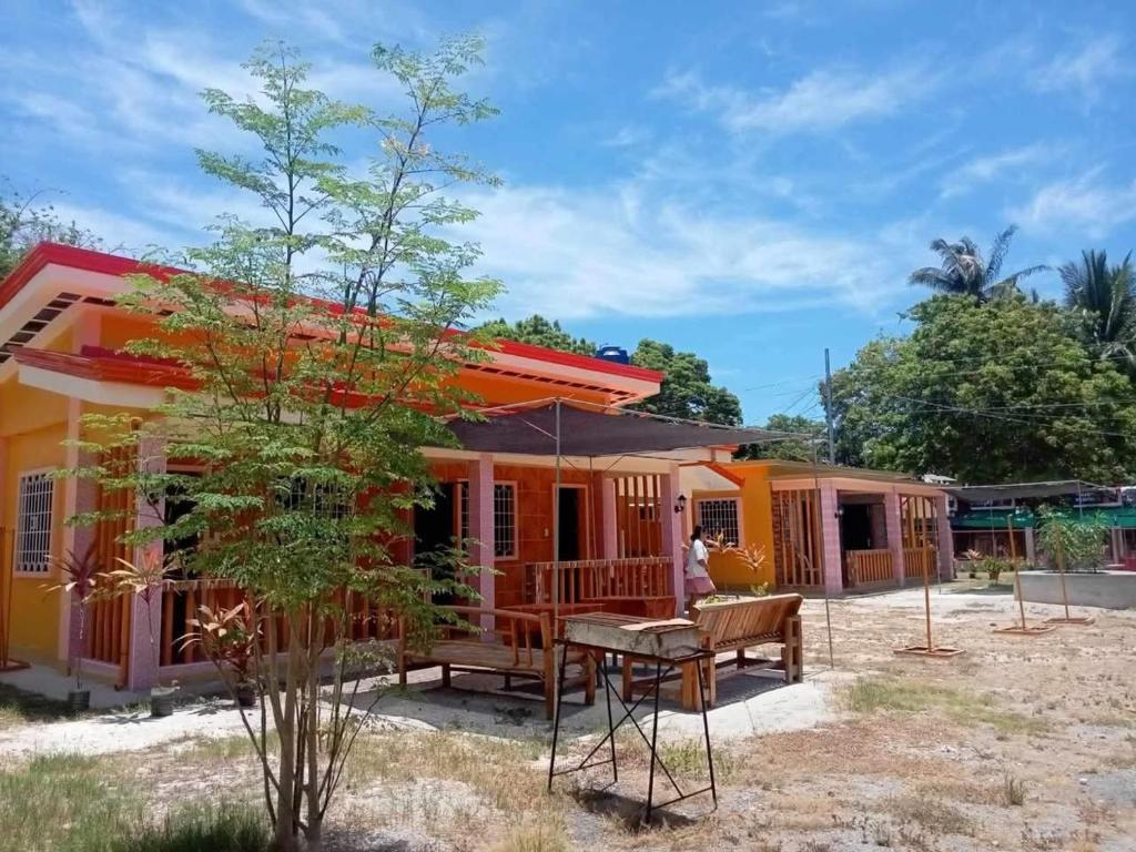 una casa con un patio y una mesa delante. en Pangga and Nanie Guest House, en Pooc