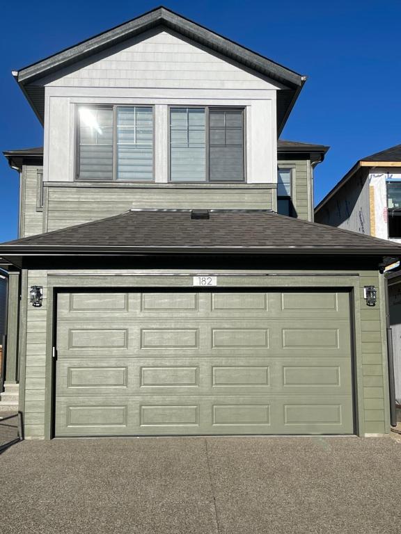 a garage door in front of a house at Exquisite 4BR & 3 Baths 2000sqft Home in Calgary