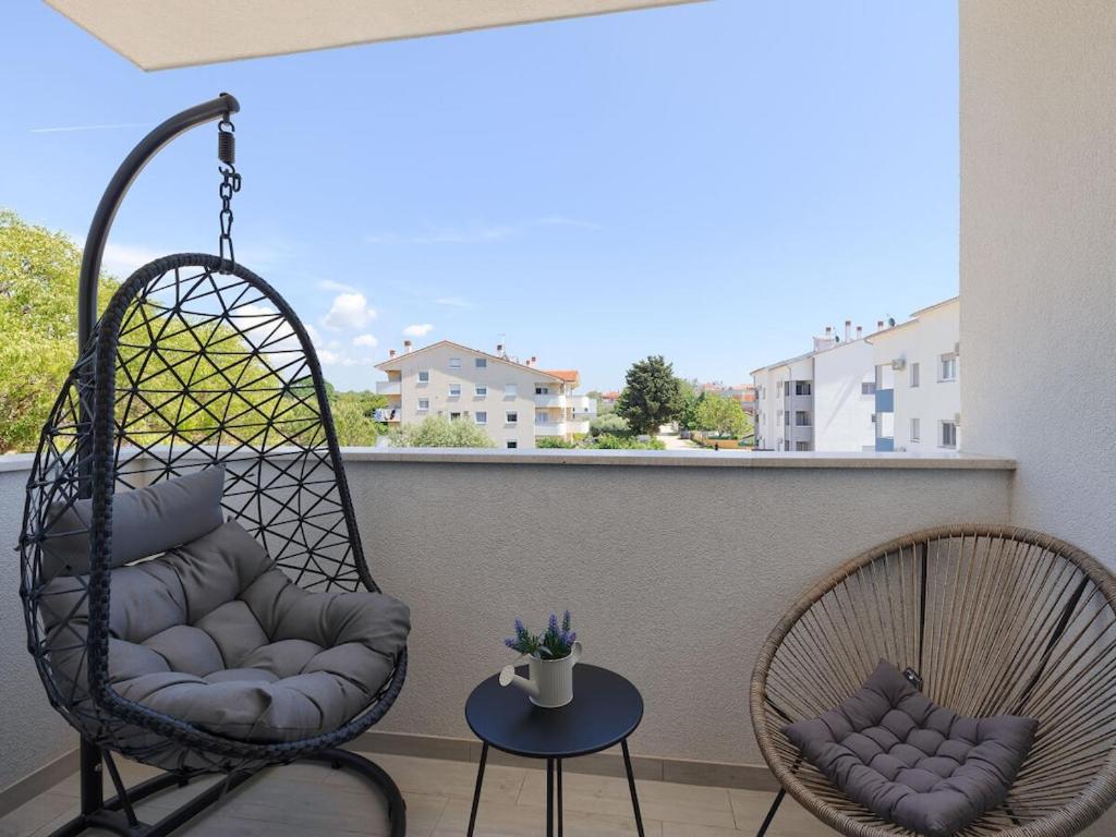 two chairs and a table on a balcony at Apartment Excellence in Pula